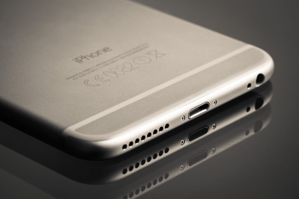 Smartfon ustawiony pod kątem z odbiciem na gładkiej powierzchni